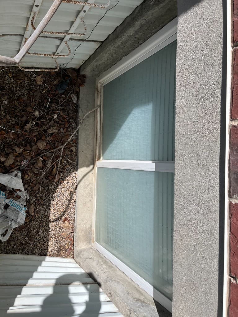 Before: Severe hard water mineral staining on window glass
