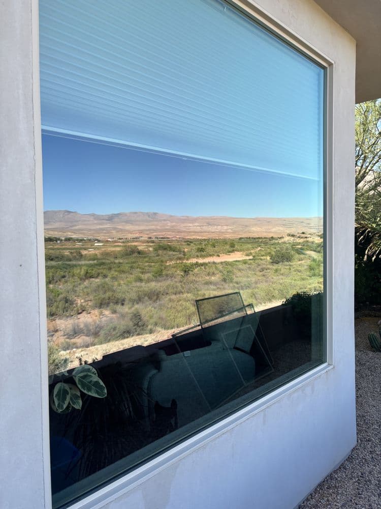 Spotless picture window with a desert view